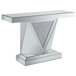 This mirrored console table features a sleek rectangular design with a bold, geometric base. The triangular inlay is adorned with acrylic crystals, enhancing its modern appeal. Made with mirrored surfaces, the console offers a sophisticated look that refl