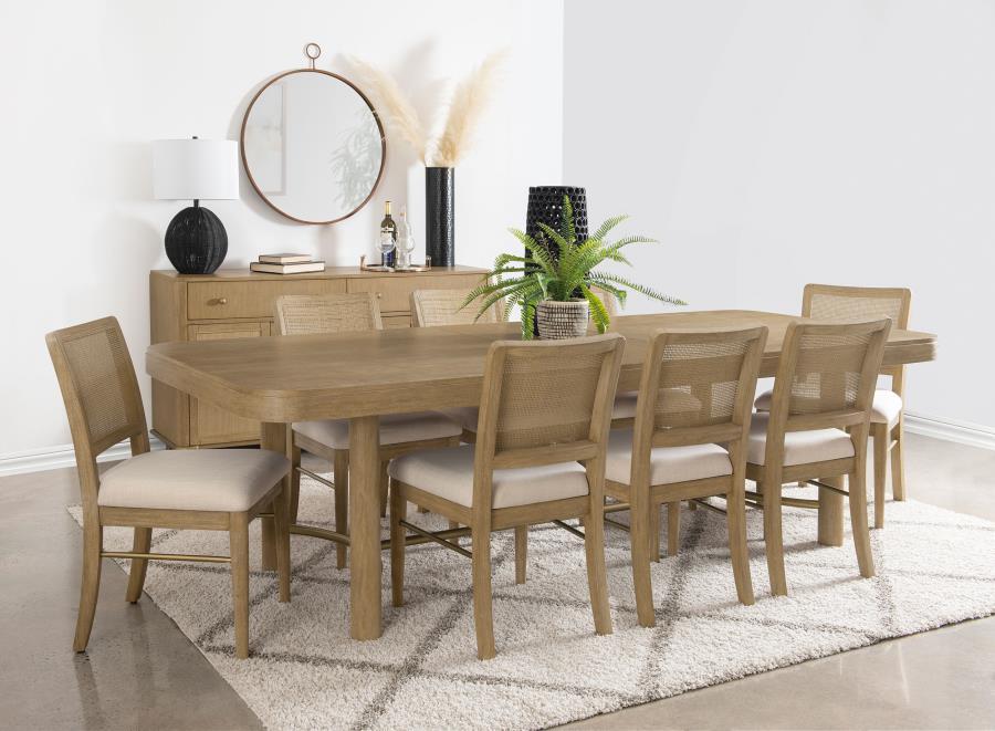 This dining set blends modern craftsmanship with natural textures for a refined yet inviting feel. The dining table features a trestle base with an antique brass-finished metal stretcher bar, adding stability and contrast. Rounded corners soften the recta