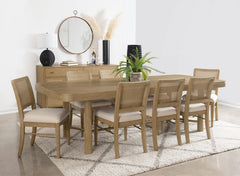This dining set blends modern craftsmanship with natural textures for a refined yet inviting feel. The dining table features a trestle base with an antique brass-finished metal stretcher bar, adding stability and contrast. Rounded corners soften the recta