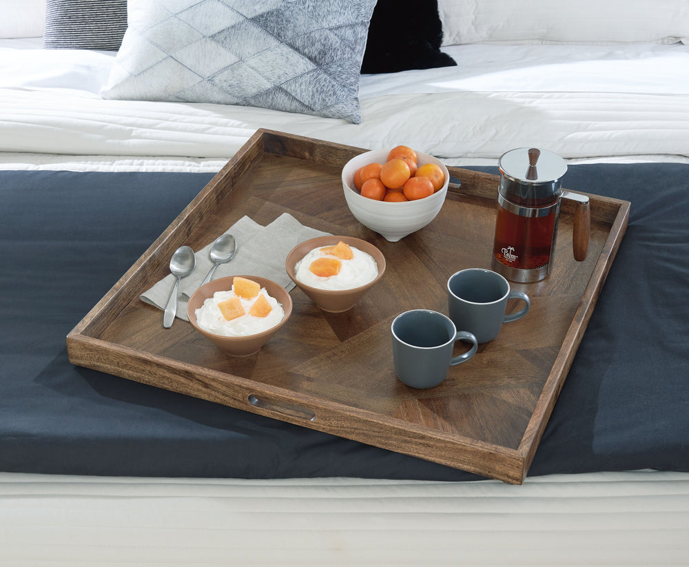 Serve up homey style with this tray. Itâ€™s a chic catch-all spot for your living room essentials when staged on an ottoman. Or place the tray on a coffee table as a beautiful base for decorative accents. With a honey brown hue and geometric wood pattern,