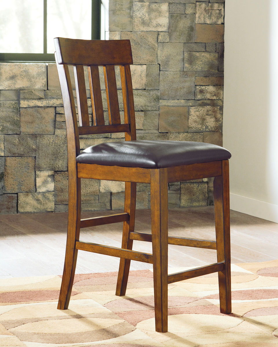 Made with select acacia veneers and hardwood solids. Gently distressed and burnished dark brown finish. D594-35 has a planked table design with thick-look tops and butterfly leaf. Seat covers in brown faux leather. Server features a working drawer along w