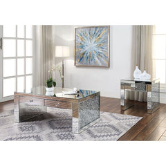 The Noralie Coffee Table will give any room a touch of glamour. This contemporary coffee table is fully mirrored with a stunning mirror top and a faux diamonds inlay on each leg of its sled base. Use this unique piece as the perfect accent for any room De