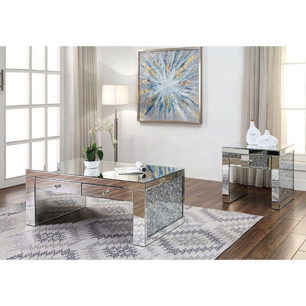 The Noralie Coffee Table will give any room a touch of glamour. This contemporary coffee table is fully mirrored with a stunning mirror top and a faux diamonds inlay on each leg of its sled base. Use this unique piece as the perfect accent for any room De