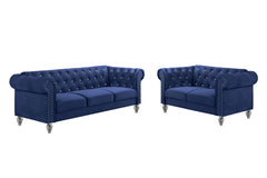The New Classic Emma Chesterfield Velvet 2-Piece Sofa and Loveseat Set offers a soft and elegant seating solution for your living space. The 100% polyester velvet fabric provides cozy and indulgent seating, while the tufted backs and arms, adorned with gl