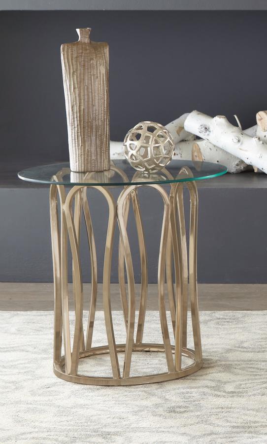 This round end table features a clear tempered glass top set atop a durable metal frame. The base is finished in electroplated chocolate chrome, offering a rich, deeper brass tone. The stylish geometric design creates an elegant look, while the tempered g