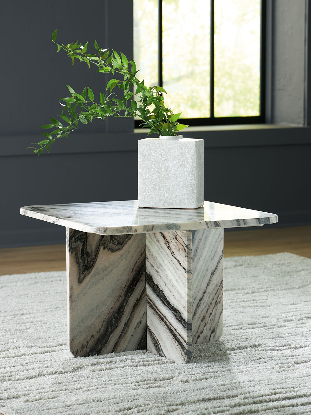 Artful. Sculptural. Stylish. All are apt descriptions of this accent cocktail table. Constructed of stunning marble in varying neutral tones, it offers an elevated interpretation of everyday style. Whether it-'s making a statement standing alone or decora
