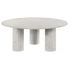 Amidst the gentle hum of daily life, this coffee table, crafted from genuine white marble, commands attention with its avant-garde design. Its round top rests on three cylindrical pedestals, each adorned with subtle grid-textured detailing. Blending the t