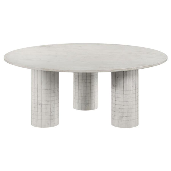 Amidst the gentle hum of daily life, this coffee table, crafted from genuine white marble, commands attention with its avant-garde design. Its round top rests on three cylindrical pedestals, each adorned with subtle grid-textured detailing. Blending the t