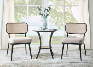 The Frydel is the perfect table set for your home. This three-piece round table set includes a glass tabletop with a rattan lower shelf and black frame, as well as two rattan chairs with a plush seat cushion. The glass and rattan, so it-'s easy to clean. 