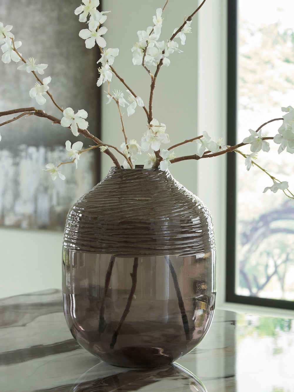 The accent is on contemporary with this exquisite glass vase. Its cool iridescent gray finish and hand-carved pattern deliver a sophisticated statement wherever you like. For those with an artful eye and a love of modern elegance, it-'s a beauty to behold
