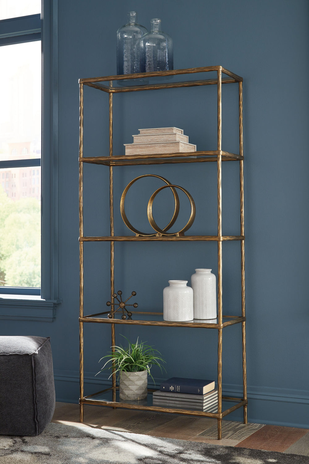 Classic in design with a dash of textural appeal, this bookcase provides endless possibilities for displaying your decor. Five shelves offer the perfect perch for potted plants, books or your favorite framed artwork. The frame-'s antiqued brass-tone finis
