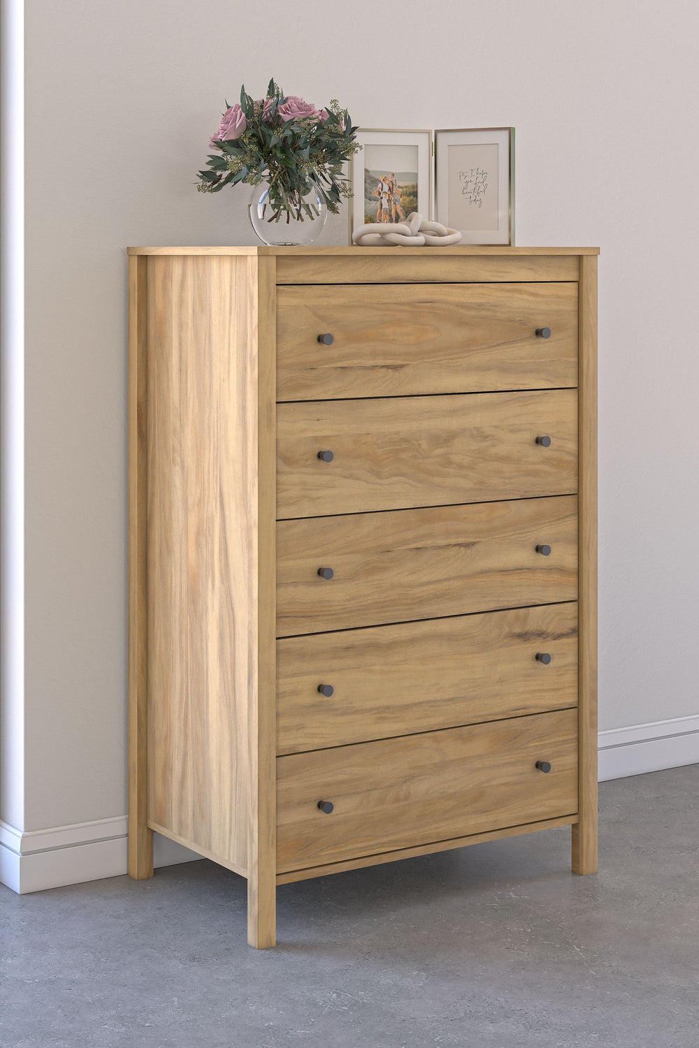 This chest of drawers puts the dream of a casual bedroom retreat beautifully within reach. A warm light brown finish over replicated hickory grain exudes a homey vibe. The smooth-gliding drawers are packed with storage possibilities. Itâ€™s a simply relax