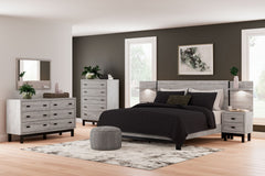 Craft a contemporary hideaway without breaking the bank. An elegant juxtaposition of refined neutral hues, the two-toned Vessalli king panel bed with extensions brings sleek style to your space. The sheer simplicity of its profile stunningly frames your m