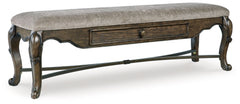 From its ornamental appliques to its large scale, this dining bench makes a bold statement. With ornately shaped legs, a plush cushioned seat and a storage drawer, the opulent bench wows with stunning style. The look is timeless. The feel? Right at home.<