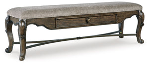 From its ornamental appliques to its large scale, this dining bench makes a bold statement. With ornately shaped legs, a plush cushioned seat and a storage drawer, the opulent bench wows with stunning style. The look is timeless. The feel? Right at home.<