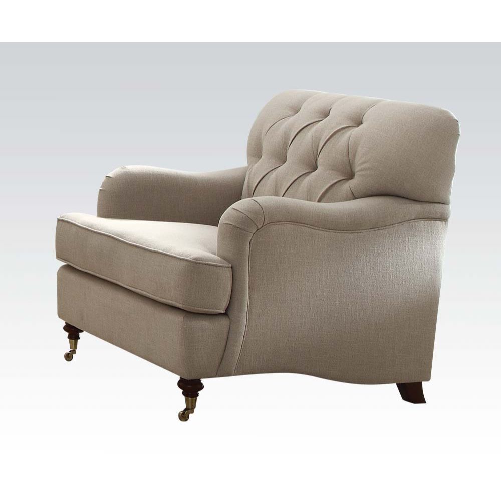 The Alianza chair is an ideal choice for any living room. This chair features a diamond tufted backrest, tight back and loose seat cushions. The beige fabric with brown fly wheel legs in the front and wooden legs in the rear, alongside the English curved 