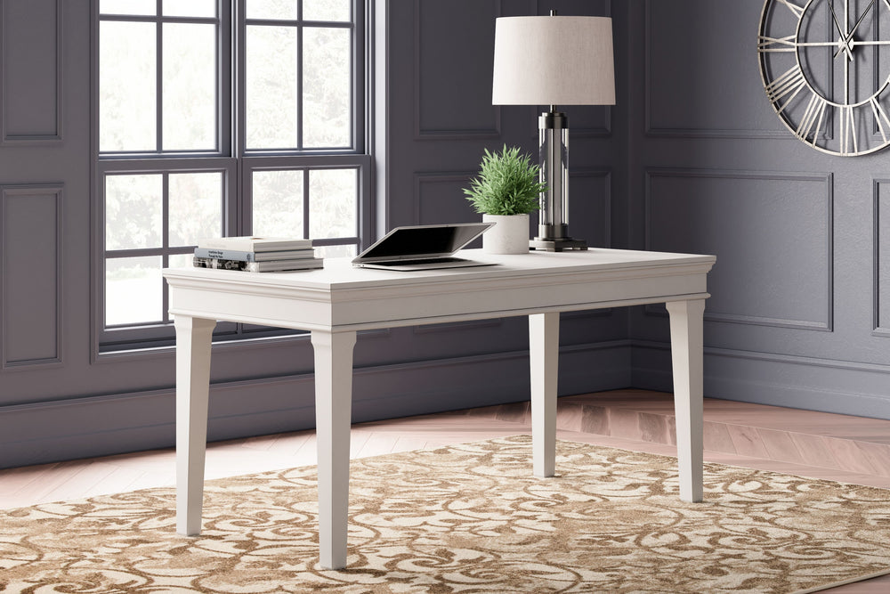 Make a style statement with this home office desk. Its traditional design is updated with an on trend distressed whitewash finish. The desk-'s large tabletop makes for a well-organized workspace.<br><br><b>Additional Dimensions</b><br><ul><li>Chair openin