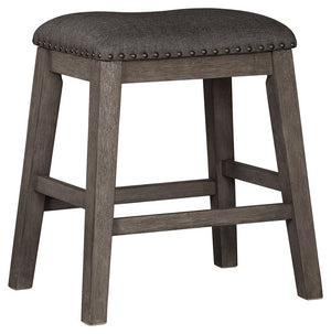 Bring a relaxed yet refined sense of good taste to a space with this upholstered stool. The clean-lined frame sports a gray-washed finish thatâ€™s so easy on the eyes. Covered in a complementary textured gray fabric, the stoolâ€™s cushioned upholstered se