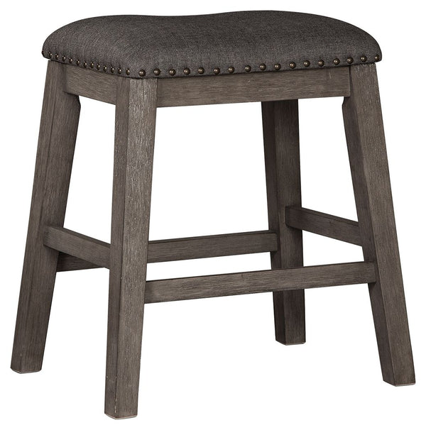 Bring a relaxed yet refined sense of good taste to a space with this upholstered stool. The clean-lined frame sports a gray-washed finish thatâ€™s so easy on the eyes. Covered in a complementary textured gray fabric, the stoolâ€™s cushioned upholstered se