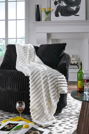  this faux fur throw turns your seating area into a haven of comfort. Its neutral hue acts as the perfect foundation for layering