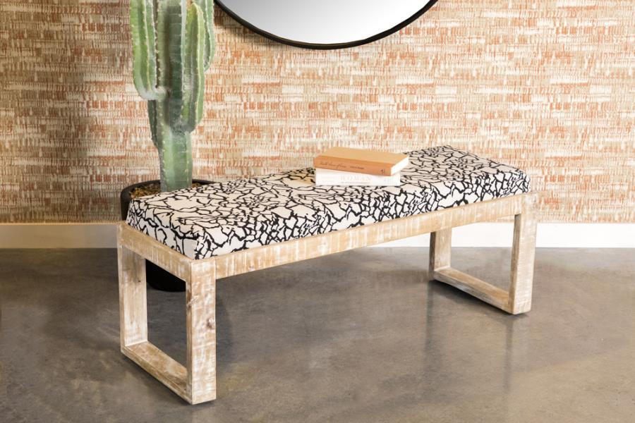 Add a bold, artistic touch to your space with this modern accent bench, featuring a striking black-and-white abstract fabric seat. The solid mango wood frame is finished in a distressed white wash, lending a rustic charm to its contemporary silhouette. Wi
