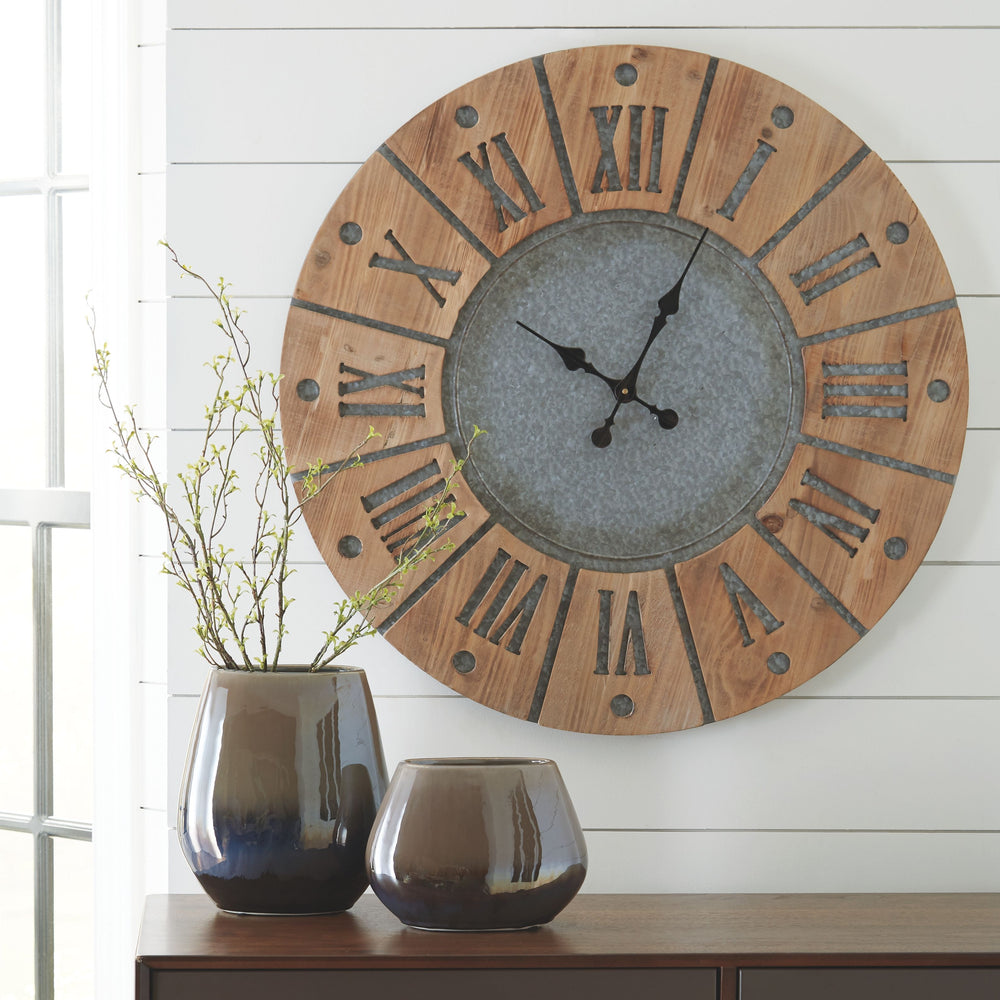 This wall clock is on time with industrial farmhouse style. Natural wood pairs beautifully with galvanized metal to create its large Roman numerals and sun design. The clockâ€™s ample scale makes it a gorgeous focal piece for your wall.<br/><br/><b>Produc