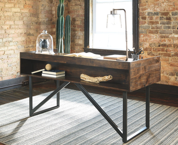  this desk steals the show. Its top is crafted with a mix of acacia veneer and wood beautified with an oiled walnut-tone finish. A sleek tubular metal frame and linear