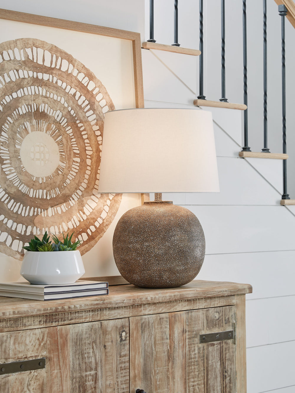 Combining premium quality materials with unique high-style design, this table lamp brings a touch of easy artisan texture to a room. Color variations throughout add an almost antique feel and make each piece unique.<br><br><b>Additional Dimensions</b><br>