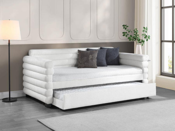  the daybed is designed with layered round bolsters