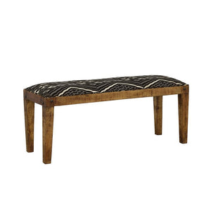 Elevate your space with this modern rustic bench, blending natural wood tones with bohemian-inspired upholstery. The solid mango wood frame showcases a rich, exposed grain, accented by decorative nailhead details for added charm. A bold black-and-white ge