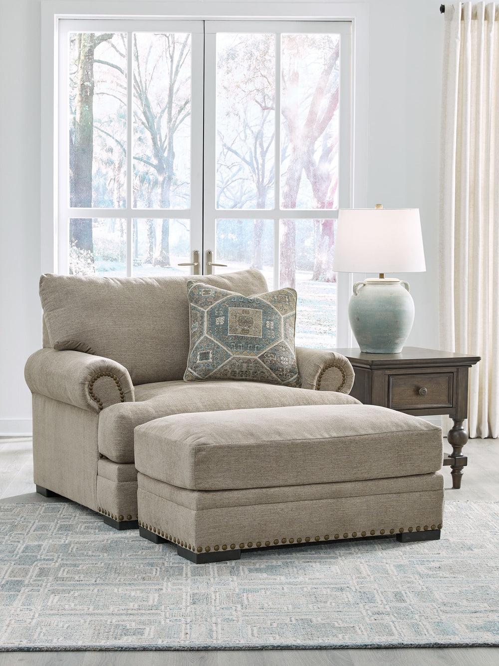 Looking to enhance your home-'s visual appeal? This oversized chair with ottoman set offers sophisticated design, comfort and elegance with tonal colors, roll arms and nailhead accents. Enjoy optimal coziness as you nestle into luxurious soft upholstery a