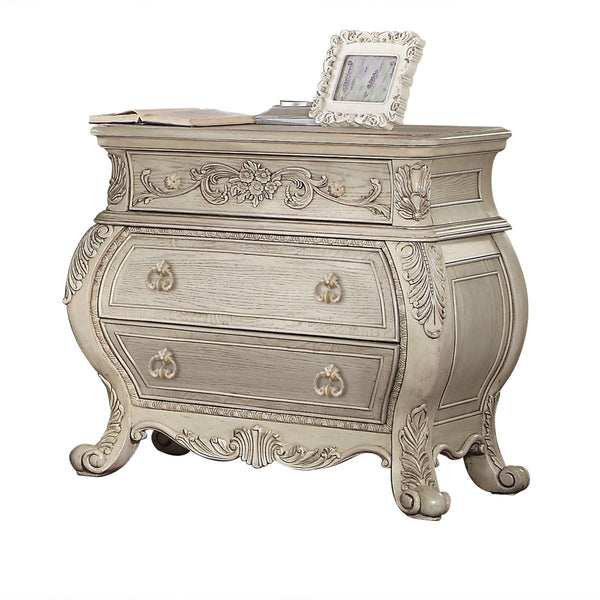 The Ragenardus nightstand is an impeccable example of truly memorable luxurious traditional design. This three-drawer antique white nightstand features a detailed French style front and English back in a stunning Bombay shape case, Felt-Lined top drawer, 