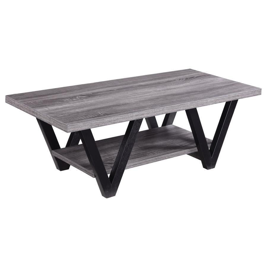 This contemporary coffee table enhances your living room with its bold, angular design and practical features. A rectangular grey wood-look top and lower shelf, crafted from engineered wood with a durable laminate veneer, provide stylish and functional su