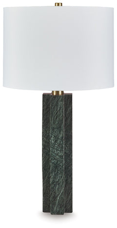 This table lamp is a master class in understated sophistication. Its sleekly dimensional base, crafted from rich green marble with subtle goldtone metal accents, adds a quietly exquisite touch to your favorite space. The statement-making lamp is a welcome