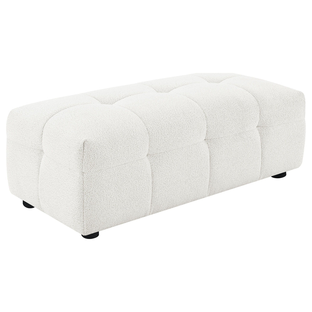 Enhance your lounging comfort with the versatile and functional ottoman. Designed to provide added leg support, this ottoman can be used as extra seating or a convenient footrest. Wrapped in soft textured boucle upholstery, it offers a plush and luxurious