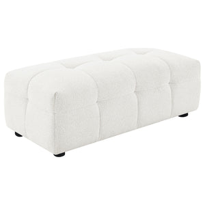 Enhance your lounging comfort with the versatile and functional ottoman. Designed to provide added leg support, this ottoman can be used as extra seating or a convenient footrest. Wrapped in soft textured boucle upholstery, it offers a plush and luxurious