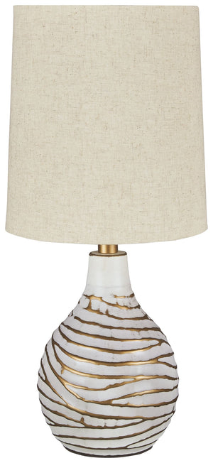 Shine a contemporary spotlight on your good taste with this table lamp. The antiqued white and goldtone finish of the metal lamp adds texture and interest to any space. With a modified drum shade, this light will illuminate your decor with style.<br><br><
