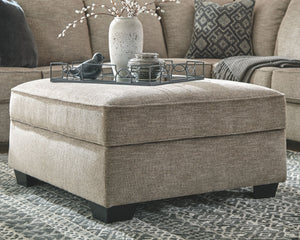  this generously sized ottoman in a stone-tone neutral upholstery has the corner on style. Merging ultimate comfort with striking good looks