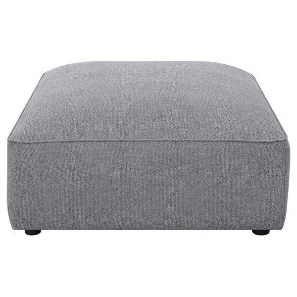  boxy shape is upholstered in a soft grey woven fabric that lends it a hint of texture. With a neutral monochromatic color palette