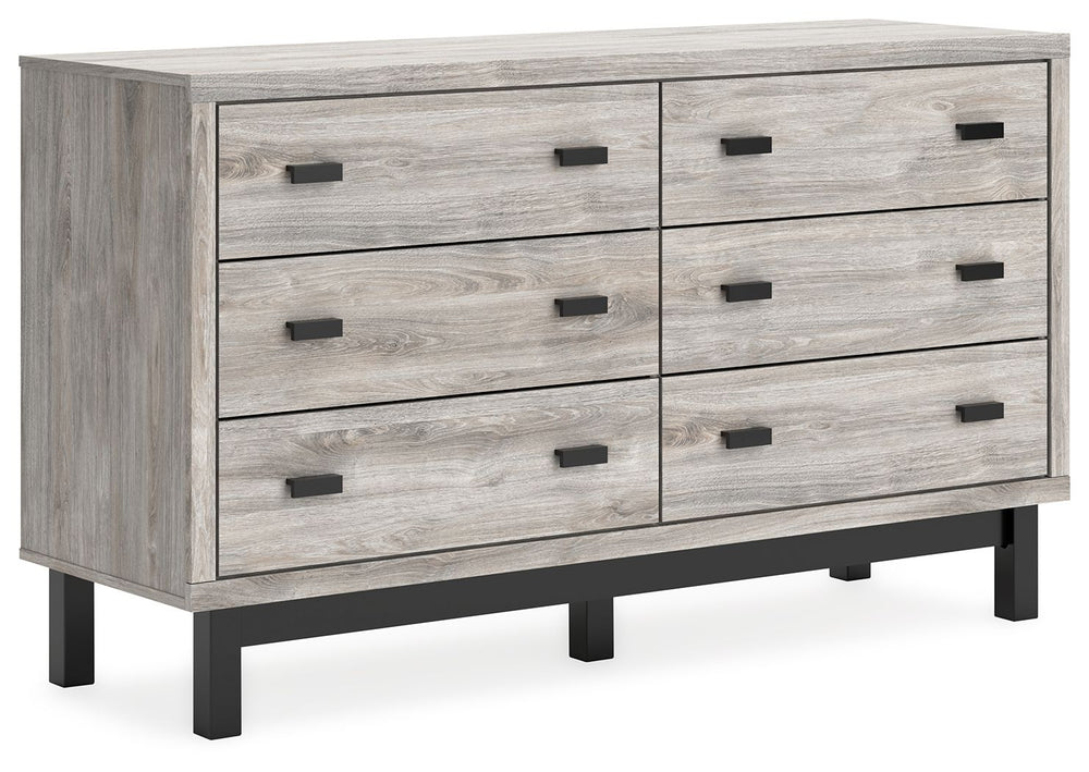 Craft a contemporary hideaway without breaking the bank. An elegant juxtaposition of refined neutral hues, this two-toned dresser brings sleek style to your space. Matte black drawer handles enhance the sheer simplicity of its profile. With this storage p