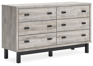 Craft a contemporary hideaway without breaking the bank. An elegant juxtaposition of refined neutral hues, this two-toned dresser brings sleek style to your space. Matte black drawer handles enhance the sheer simplicity of its profile. With this storage p