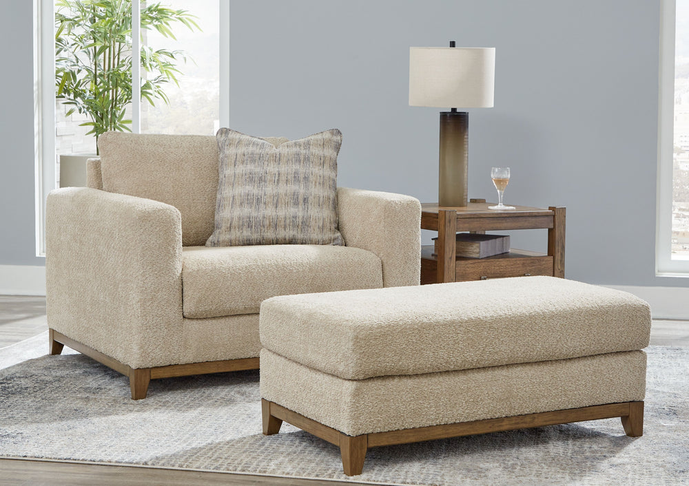 Serene style with a modern sensibility. Delight in the cozy, versatile embrace of this living room set. It takes an on-trend approach to irresistible texture and natural beauty, showcasing soft neutral upholstery accented with a transitional wood trim. As