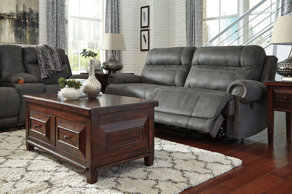 Take a rest with this living room set. Subtle touches such as sporty jumbo stitching, nailhead trim and a -"weather worn-" effect on the upholstery give this handsome set a buttoned-up appeal and fresh feel. Loveseat has center console with dual cup holde