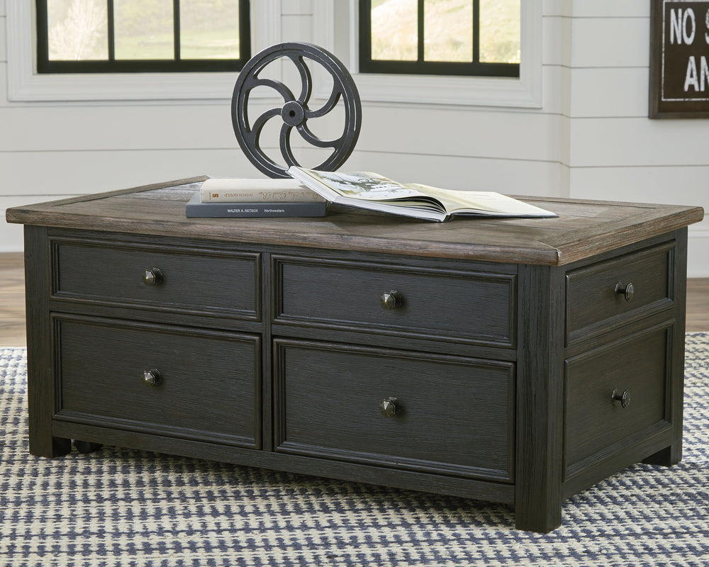 Shabby chic with a hint of down-home country, this lift-top coffee table is all the talk of todayâ€™s design world. Wood grain shows through the weathered gray-brown top in all of its earthy pleasure. The framed drawers, adorned with lovely traditional ha