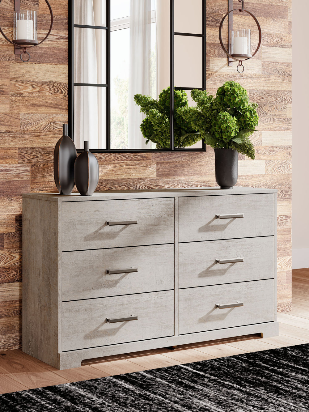 Give casual a new meaning with the chic look of this dresser. A light gray finish over replicated oak grain keeps it laid-back and inviting, while substantial pulls in a warm pewter tone add a modern farmhouse touch. Spacious drawers give you plenty of ro