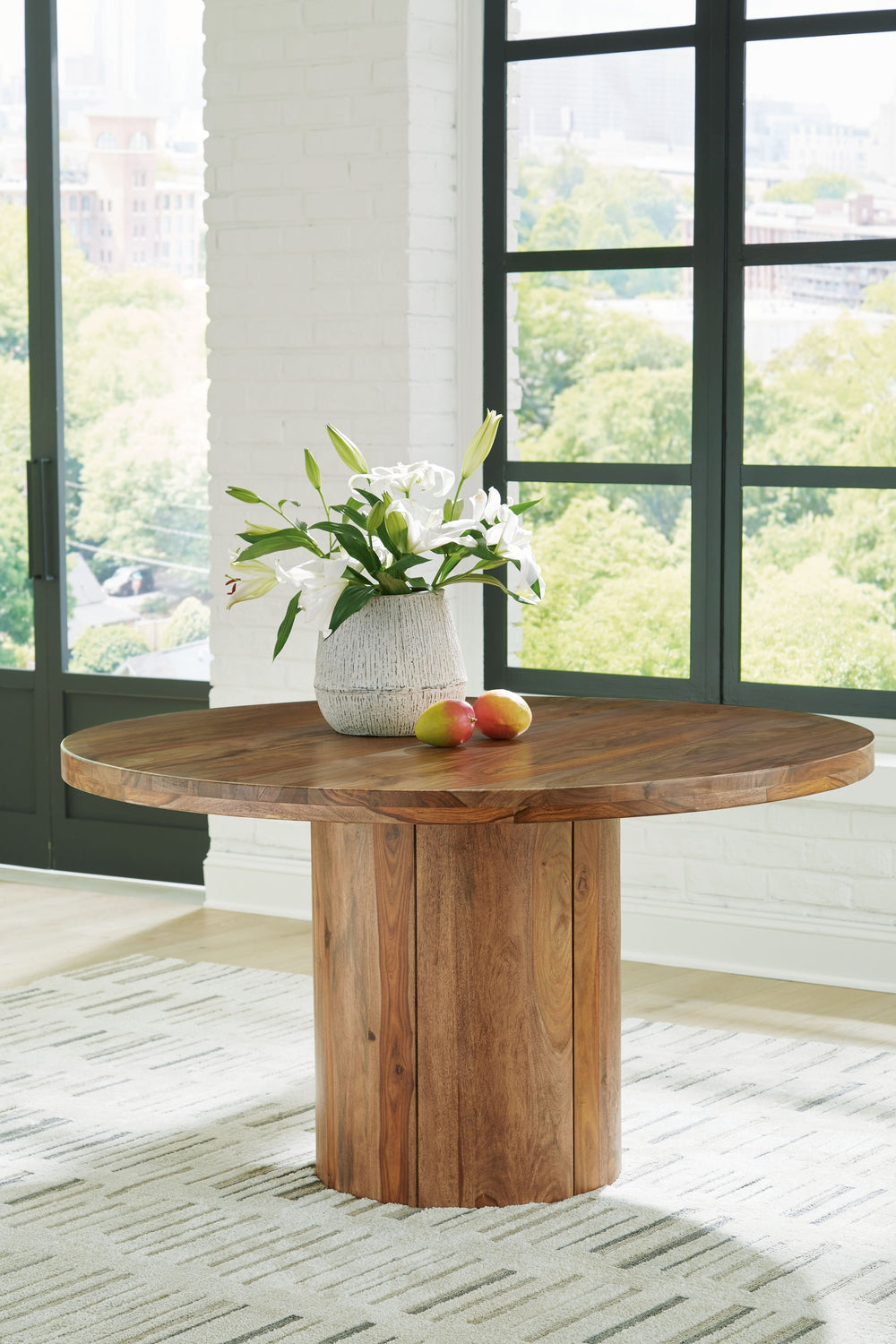 Discover something extraordinary with this clean-lined dining table. The rich natural beauty of the solid wood round pedestal and sturdy top brings an organically stunning vibe to your home. Strikingly simple, this piece creates an understated, modern fea