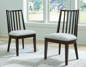  with an aged black finish defining the chic curved backrest. And the chairâ€™s color palette is stunningly simple