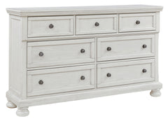 Elegant, timeless furnishings take your bedroom to the next level. Nothing does that better than this dresser. The antiqued white finish with a wonderful grain texture radiates sophistication, while the dark bronze-tone hardware adds an ornate touch. A hi