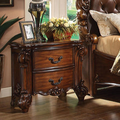 Create an elegant, traditional design in your bedroom with the cherry Vendome nightstand. This hand-crafted piece inspired from the luxurious designs of the past, this two-drawer nightstand features elaborate wood carving details, traditional hardware and