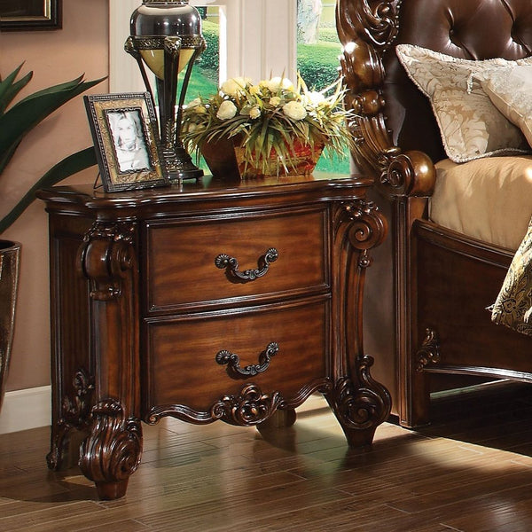 Create an elegant, traditional design in your bedroom with the cherry Vendome nightstand. This hand-crafted piece inspired from the luxurious designs of the past, this two-drawer nightstand features elaborate wood carving details, traditional hardware and